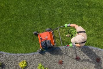 Bird’s eye view of a man cutting the borders of a lawn